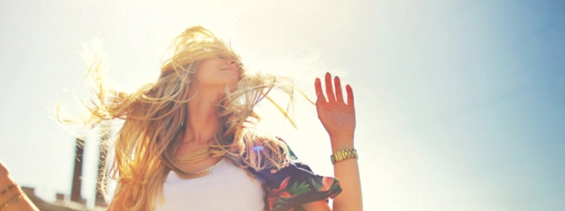 Woman with healthy, flowing hair in bright sunlight
